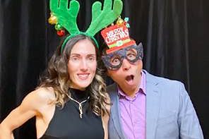Two guests in antlers and novelty glasses at a photo booth, photographed by Dario Hudon