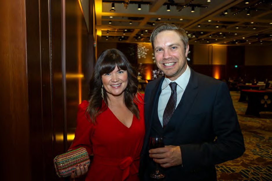 Two guests dressed for the evening at a company holiday party, photographed by Dario Hudon