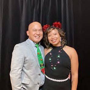 Two guests in holiday accessories at a photo booth, photographed by Dario Hudon