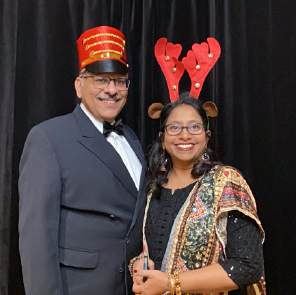 Two guests in a toy soldier hat and reindeer antlers at a photo booth, photographed by Dario Hudon
