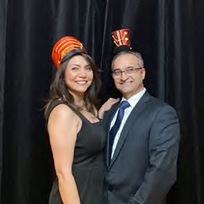 A couple in festive hats at a photo booth, photographed by Dario Hudon