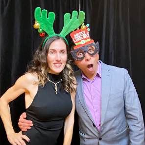 Two guests in antlers and novelty glasses at a photo booth, photographed by Dario Hudon