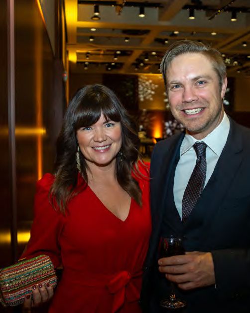 Two guests dressed for the evening at a company holiday party, photographed by Dario Hudon